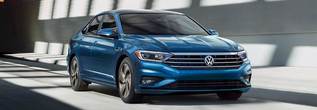 Volkswagen Jetta driving on a road